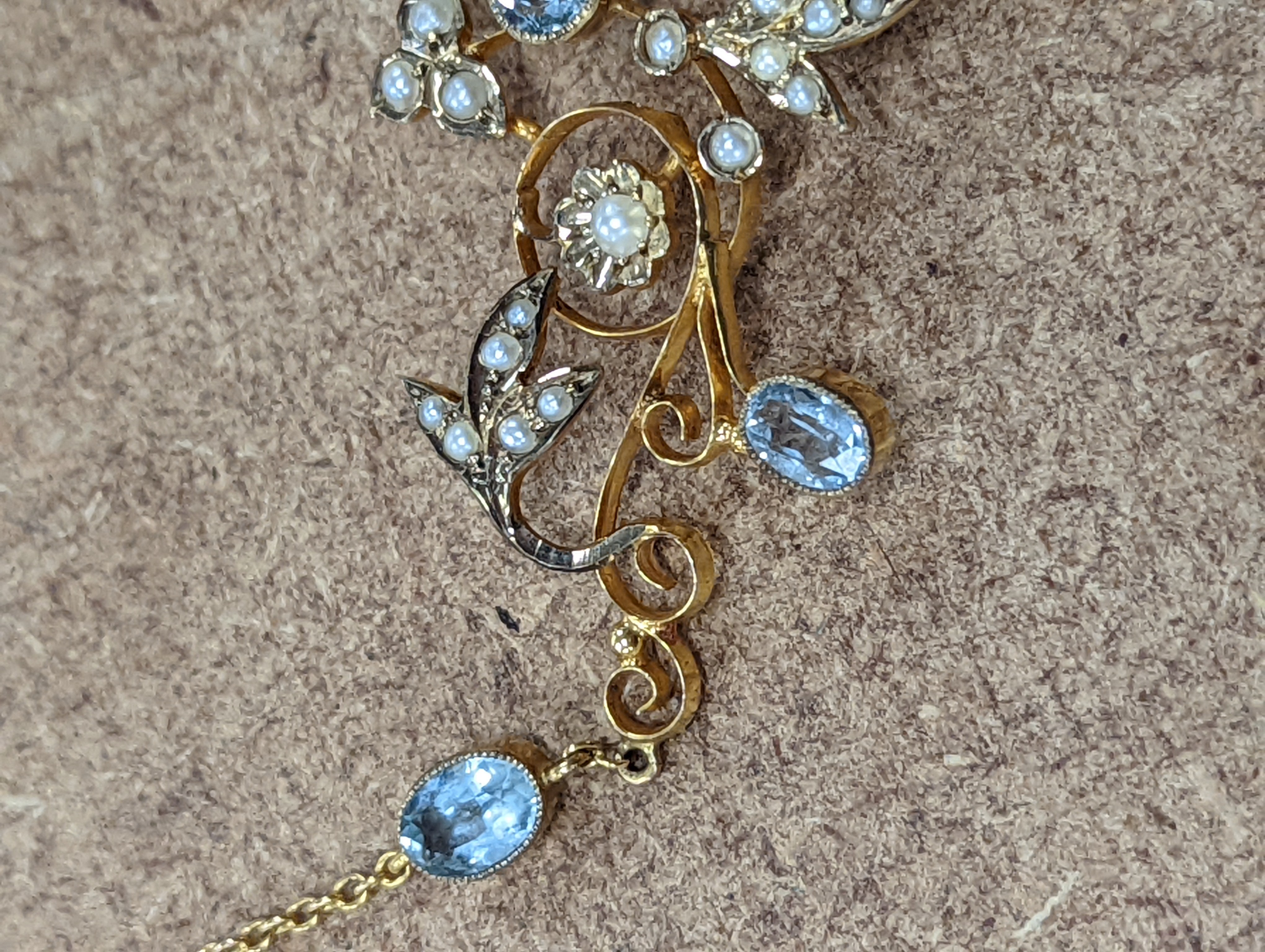 An Edwardian 9ct, aquamarine and seed pearl set drop pendant necklace, 40cm, gross weight 7.2 grams.